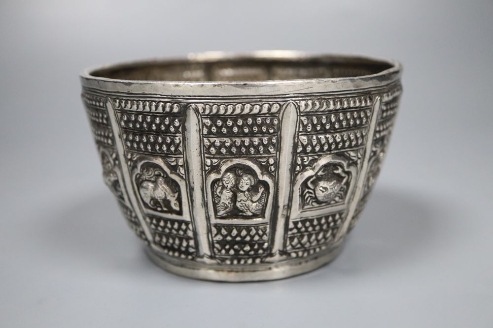 An early 19th century Burmese white metal, embossed with figures, fish, animals and crustaceans, diameter 12.3cm, 7oz.